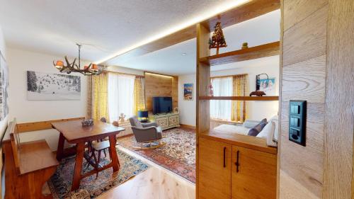 a living room with a desk and a bedroom at Chesa Centrum in Celerina