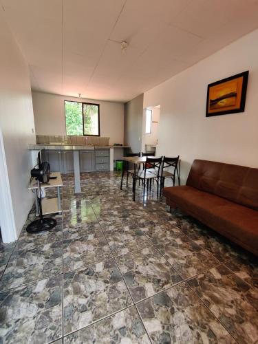 a living room with a couch and a table at Cabinas Maritza in Quebrada Ganado