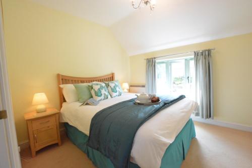 a bedroom with a bed and a window at Seafarers in Fressingfield
