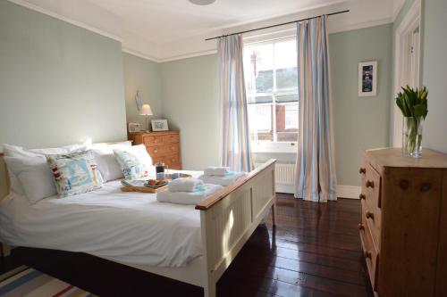 a bedroom with a large white bed and a window at Lavender House, Aldeburgh in Aldeburgh