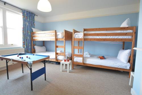 a room with two bunk beds and a pool table at Lavender House, Aldeburgh in Aldeburgh