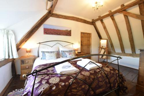 a bedroom with a bed in a attic at 1 Grange Cottages, Westleton in Westleton