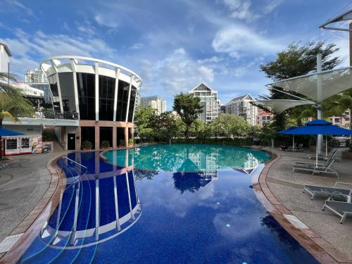 a large swimming pool in a city with a building at River Place in Singapore