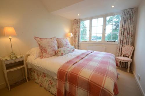 a small bedroom with a bed and a window at 2 The Bays, Thorpeness in Thorpeness