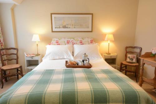 a bedroom with a large bed with a tray on it at 2 The Bays, Thorpeness in Thorpeness