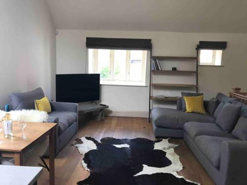 a living room with a couch and a table at LOBSTER COTTAGE (Norfolk Costal Cottage) in Langham