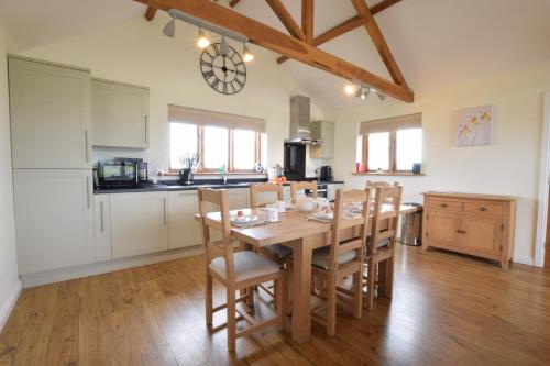 a kitchen and dining room with a table and chairs at The Mulberry, nr Bungay in Bungay