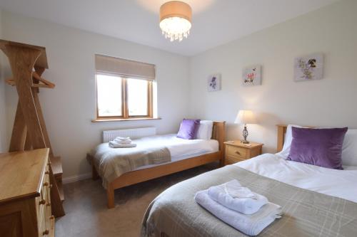 a bedroom with two beds and a window at The Mulberry, nr Bungay in Bungay
