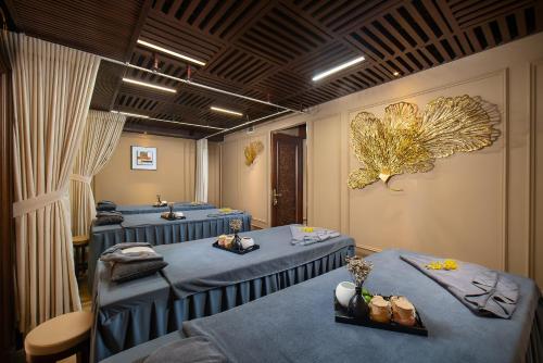 a row of blue beds in a waiting room at The Q Hotel in Hanoi