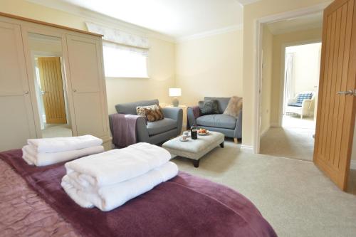 a living room with a couch and a table at Meadowsweet, Blythburgh in Blythburgh