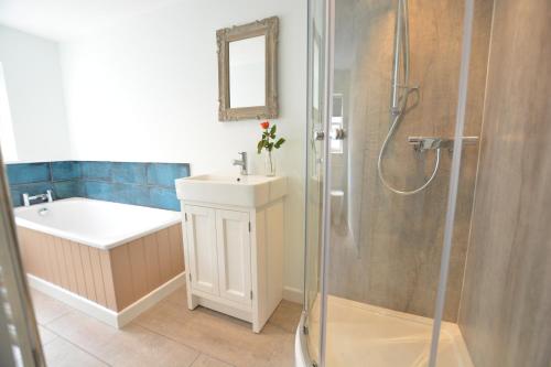 a bathroom with a sink and a shower at Alinka, Aldeburgh in Aldeburgh