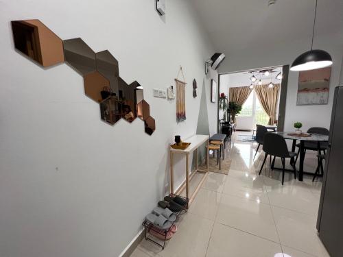 a living room and dining room with white walls at Urban Gateway Homestay# Bangi#Wifi 300Mbps#Netflix in Kampong Tangkas