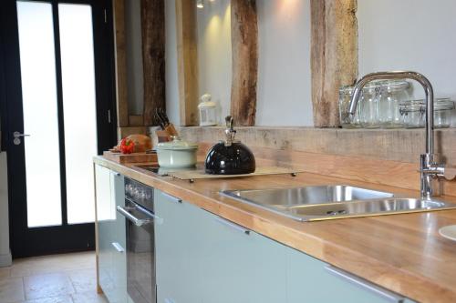 a kitchen with a sink and a counter top at Manor House Barn, Peasenhall in Peasenhall