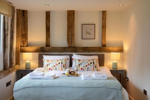 a bedroom with a bed with a teddy bear on it at Manor House Barn, Peasenhall in Peasenhall