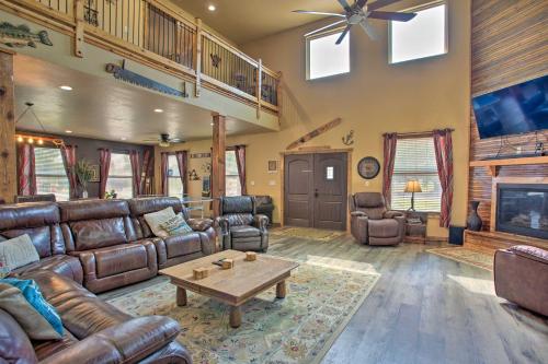 a living room with leather couches and a coffee table at Kingston Home with Pickleball Steps to Lake Texoma! in Kingston
