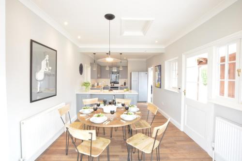a kitchen and dining room with a table and chairs at The Round House in Kettleburgh