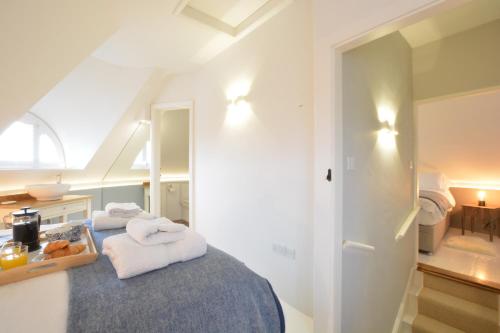 a bedroom with a bed with towels on it at The Round House in Kettleburgh