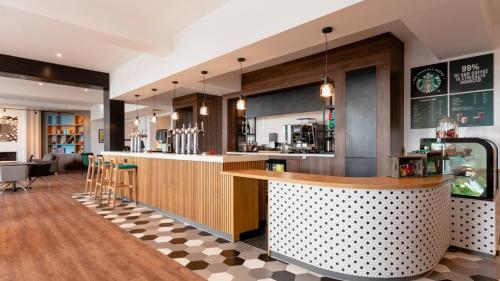 a bar in a restaurant with a counter at Holiday Inn Darlington-A1 Scotch Corner by IHG in Scotch Corner