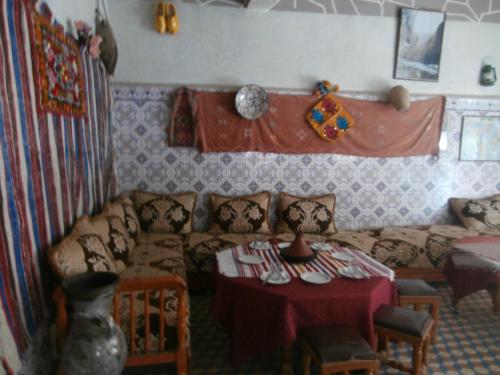 a living room with a couch and a table at Etoile des Gorges in Aït Baha
