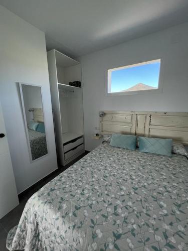 a bedroom with a large bed and a window at El Gallinero in Almoharín