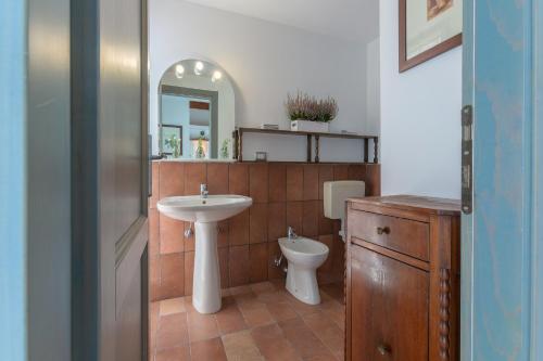 a bathroom with a sink and a toilet and a mirror at Francolino Duplex Charming La Farnia Villa in Francolino