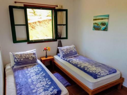 Ένα ή περισσότερα κρεβάτια σε δωμάτιο στο Casa Flor azul