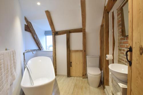 a bathroom with a toilet and a sink at Old Bloxhall House, Hitcham in Lavenham
