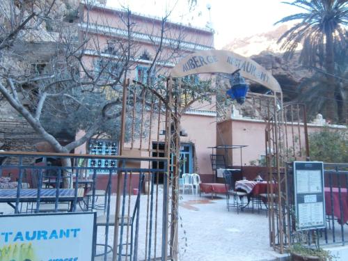 a restaurant with tables and chairs in front of a building at Etoile des Gorges in Aït Baha