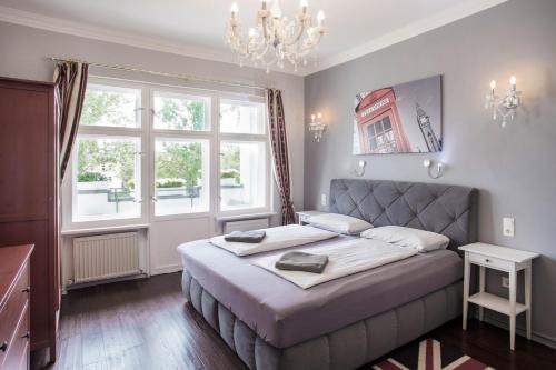 a bedroom with a large bed and a large window at Holidayapartments Marquardt in Berlin