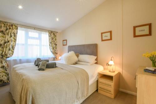 a bedroom with a large white bed with a window at The Hide Out, Aldeburgh in Aldeburgh