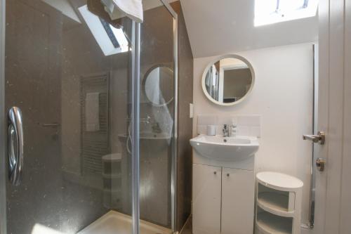 a bathroom with a shower and a sink at The Gallery, Blythburgh in Blythburgh