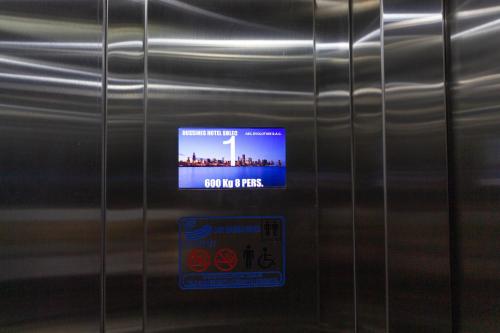 a sign on the side of a stainless steel refrigerator at Hotel Solec in Chiclayo