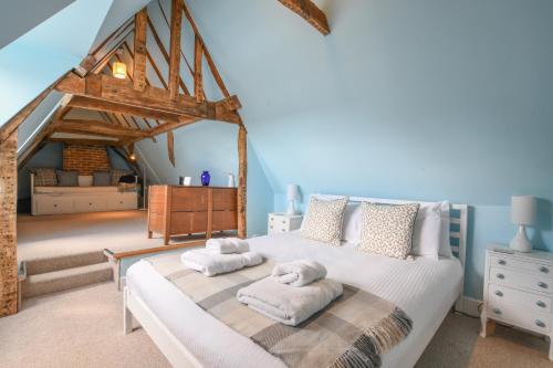 a bedroom with a bed with towels on it at Beresford House in Woodbridge