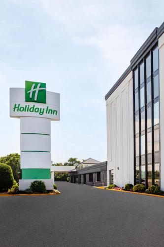 a building with a holiday inn sign in front of it at Holiday Inn Hasbrouck Heights-Meadowlands by IHG in Hasbrouck Heights