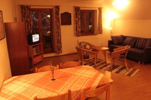 a living room with a table and a couch at Dolní Náměstí in Rokytnice nad Jizerou