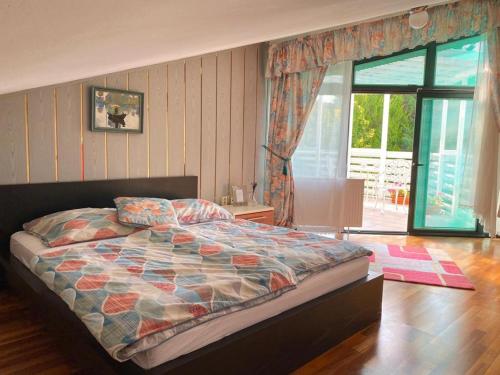 a bedroom with a bed and a sliding glass door at Cozy rooms in wine town - Modra in Modra