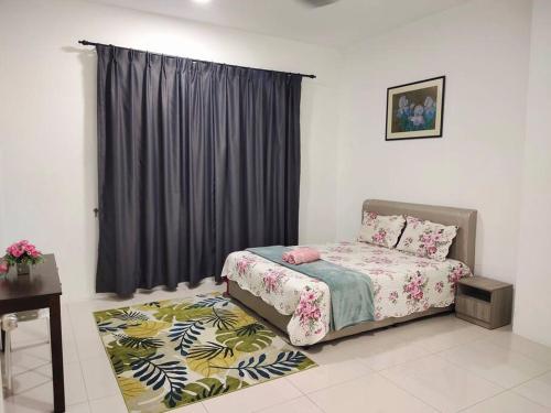 a bedroom with a bed and a window and a rug at D'MEDINA @ Icon Residence in Kuala Terengganu