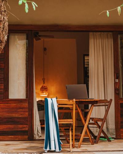 a table with a laptop computer on top of it at Hurricane Jeri in Jericoacoara