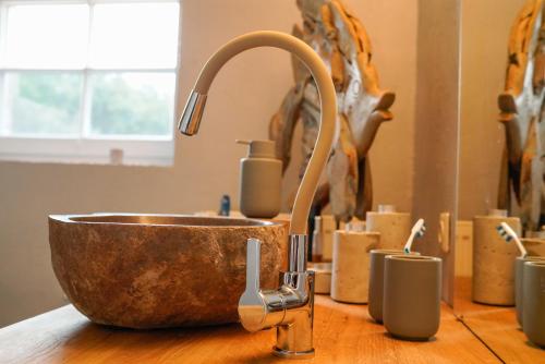 a copper sink on a wooden counter with candles at Apartment Mini-Loft am Schloss in Raesfeld