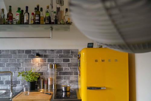 a yellow refrigerator in a kitchen next to a counter at Apartment Mini-Loft am Schloss in Raesfeld