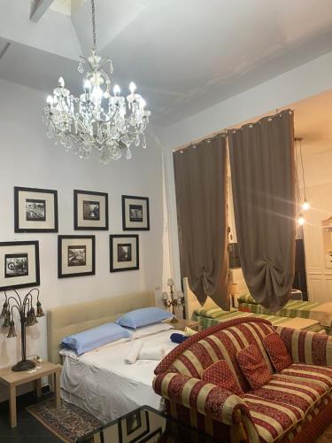 a bedroom with a bed and a chandelier at Al 20 Guest House Fiera Milano - Certosa - San Siro in Milan