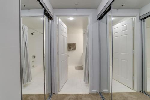 a hallway with a glass door and a bathroom at Sensational 1 Bedroom Condo At Ballston place With Gym in Arlington