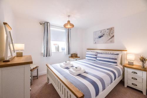 ein Schlafzimmer mit einem Bett mit zwei Handtüchern darauf in der Unterkunft Coasters in Aldeburgh