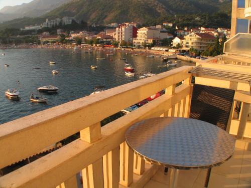 a balcony with a table and a view of a harbor at Apartments Stević - Monaco in Budva