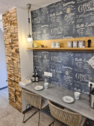 a chalkboard wall in a restaurant with a table and chairs at Stylisches Garden Cottage in Weyhe