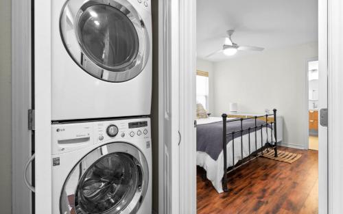a washer and dryer in a room with a bed at The Little Canary in Rockport