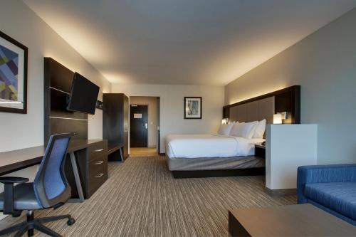 a hotel room with a bed and a desk at Holiday Inn Express & Suites - Mount Vernon by IHG in Mount Vernon