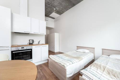 a kitchen with two beds and a table in it at LKS Apartment 5 in Tallinn