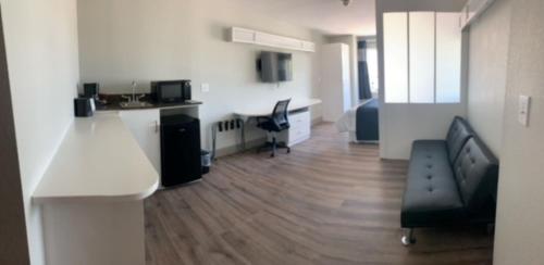 a white room with a desk and a table and a chair at Crystal Inn in Port Arthur