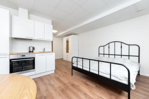 a bedroom with a bunk bed and a kitchen at LKS Apartment 3 in Tallinn